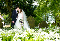 bride-groom-kiss-churchyard-richard-linnett-photography